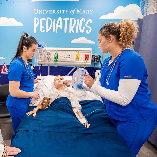 Students working in the Pediatrics simulation labs on campus.